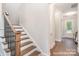View of the home's staircase with wood treads and black iron balusters leading to the upper level at 20396 Queens St, Cornelius, NC 28031