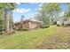 Charming brick home with a large backyard and a swing under a tree on a partially sunny day at 211 General Stonewall Jackson Dr, Stanley, NC 28164