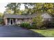 Charming brick home featuring well-maintained landscaping, a spacious driveway, and a welcoming screened entrance at 211 General Stonewall Jackson Dr, Stanley, NC 28164