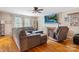 Bright living room with a fireplace, hardwood floors, and large windows providing natural light at 211 General Stonewall Jackson Dr, Stanley, NC 28164