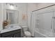 Bright bathroom featuring a shower-tub combo, grey vanity, and a neutral color scheme at 2185 Loire Valley Dr, Fort Mill, SC 29707