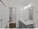 A bright bathroom featuring a walk-in shower and a vanity with a large mirror at 2185 Loire Valley Dr, Fort Mill, SC 29707