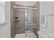 Bathroom featuring glass enclosed shower with dark tile and modern fixtures at 2185 Loire Valley Dr, Fort Mill, SC 29707