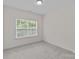 Bright bedroom with neutral carpet, white walls, and large windows with natural light at 2185 Loire Valley Dr, Fort Mill, SC 29707