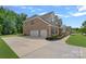 Beautiful brick house with a spacious three-car garage and a well-manicured lawn at 2185 Loire Valley Dr, Fort Mill, SC 29707