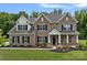Stunning brick home featuring manicured lawn, elegant black shutters, and impeccable landscaping at 2185 Loire Valley Dr, Fort Mill, SC 29707