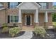 Welcoming front porch featuring brick columns, black mulch landscaping, and elegant front door at 2185 Loire Valley Dr, Fort Mill, SC 29707