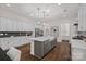 Open-concept kitchen with white cabinets, gray island, stainless appliances, and pendant lighting at 2185 Loire Valley Dr, Fort Mill, SC 29707