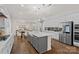 Open-concept kitchen with white cabinets, gray island, stainless appliances, and pendant lighting at 2185 Loire Valley Dr, Fort Mill, SC 29707