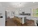 Spacious kitchen features a large island, stainless steel appliances, and elegant pendant lighting at 2185 Loire Valley Dr, Fort Mill, SC 29707