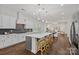 Open-concept kitchen with white cabinets, gray island, stainless appliances, and pendant lighting at 2185 Loire Valley Dr, Fort Mill, SC 29707