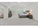 Serene main bedroom with tray ceiling, soft carpeting, and abundant natural light from multiple windows at 2185 Loire Valley Dr, Fort Mill, SC 29707