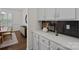 Serving area features elegant cabinetry, dark backsplash and quartz countertop, perfect for entertaining at 2185 Loire Valley Dr, Fort Mill, SC 29707