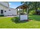 Well feature in backyard surrounded by flower beds and adjacent to white bench seat at 2315 Lanesboro Rd, Marshville, NC 28103