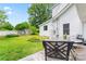 Beautiful backyard with lush lawn, mature trees, and comfortable seating area on deck at 2315 Lanesboro Rd, Marshville, NC 28103