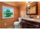 Charming bathroom with wood walls, granite countertop, and a view of the outdoors at 2315 Lanesboro Rd, Marshville, NC 28103