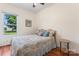 Bedroom with hardwood floors and a bright window showcasing views of mature trees at 2315 Lanesboro Rd, Marshville, NC 28103