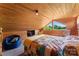 Comfortable bedroom with sloped ceilings, unique window, and cozy furnishings at 2315 Lanesboro Rd, Marshville, NC 28103