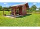 Quaint red barn style outbuilding featuring a porch with porch swing and adjoins a horse pasture at 2315 Lanesboro Rd, Marshville, NC 28103