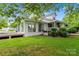 Home's rear exterior with a sunroom, deck, and a spacious yard perfect for relaxation and outdoor activities at 2315 Lanesboro Rd, Marshville, NC 28103