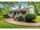 Charming two-story home with a welcoming front porch, lush landscaping, and a curved sidewalk at 2315 Lanesboro Rd, Marshville, NC 28103