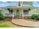 Inviting home featuring a covered front porch, white railings, and meticulously maintained landscaping at 2315 Lanesboro Rd, Marshville, NC 28103