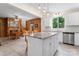 Well-lit kitchen flowing into the dining area, featuring white cabinets and granite countertops at 2315 Lanesboro Rd, Marshville, NC 28103