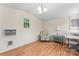 Bright living area with wood floors, chair, side table, and window air conditioning unit at 2315 Lanesboro Rd, Marshville, NC 28103