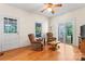 Cozy living room features hardwood floors, ceiling fan, and sliding glass door to the sun room at 2315 Lanesboro Rd, Marshville, NC 28103