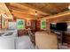 Cozy living room featuring wood paneled walls, a kitchenette, and comfortable seating at 2315 Lanesboro Rd, Marshville, NC 28103