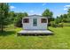 View of the charming outbuilding with a small porch and a well-maintained green lawn at 2315 Lanesboro Rd, Marshville, NC 28103