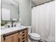 Bathroom featuring a wooden vanity with sink and a bathtub with shower at 2331 Whitford Ln, Charlotte, NC 28210