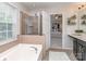 Bright bathroom with a glass-enclosed shower, soaking tub, and elegant fixtures at 2331 Whitford Ln, Charlotte, NC 28210