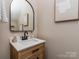 Modern bathroom with a stylish wood vanity, white countertop and contemporary fixtures at 2331 Whitford Ln, Charlotte, NC 28210