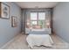Cozy bedroom with a neutral color scheme, plush carpet, and ample natural light at 2331 Whitford Ln, Charlotte, NC 28210