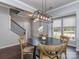 Open dining area with modern lighting, hardwood floors, and views of the front yard at 2331 Whitford Ln, Charlotte, NC 28210