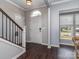 Light-filled foyer with hardwood floors, staircase, and a view to the outdoors through a window at 2331 Whitford Ln, Charlotte, NC 28210