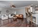 Open-concept living room showcasing hardwood floors, a neutral color palette, and ample natural light at 2331 Whitford Ln, Charlotte, NC 28210