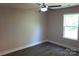 A bright bedroom with hardwood floors, ceiling fan, and a window with natural light at 256 Lincoln Sw St # 1, Concord, NC 28025