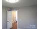 A cozy bedroom with hardwood floors and freshly painted neutral walls at 256 Lincoln Sw St # 1, Concord, NC 28025