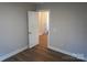 A cozy bedroom with hardwood floors and freshly painted neutral walls at 256 Lincoln Sw St # 1, Concord, NC 28025