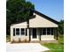 Inviting exterior with black trim, neutral siding, front porch, and new concrete driveway at 256 Lincoln Sw St # 1, Concord, NC 28025
