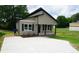 Charming single-story home with tan siding, black accents, and a new concrete driveway at 256 Lincoln Sw St # 1, Concord, NC 28025