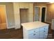 Bright kitchen with white cabinets, island with quartz countertop, and stainless steel appliances at 256 Lincoln Sw St # 1, Concord, NC 28025
