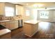 Open concept kitchen with stainless steel appliances, quartz countertop, and a view of the living room at 256 Lincoln Sw St # 1, Concord, NC 28025
