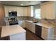 Modern kitchen features white cabinetry, stainless steel appliances, and quartz countertops at 256 Lincoln Sw St # 1, Concord, NC 28025