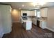 New kitchen boasts white cabinets, an island, stainless steel appliances, and wood floors at 256 Lincoln Sw St # 1, Concord, NC 28025
