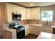 Modern kitchen with stainless steel appliances, white cabinets, and an island at 256 Lincoln Sw St # 1, Concord, NC 28025