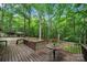 A wood back deck features a lovely view of the surrounding trees and a detached garage at 3000 Low Gap Rd, Waxhaw, NC 28173