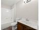 Bathroom featuring earth tone flooring, white shower bath, toilet, and dark vanity at 3000 Low Gap Rd, Waxhaw, NC 28173
